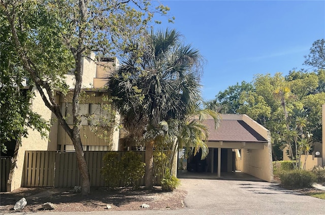 204 Tomoka Trl Unit 204, Longwood, FL 32779 - view of property hidden behind natural elements featuring fence, stucco siding, and aphalt driveway