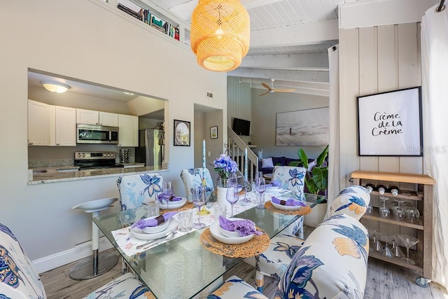 204 Tomoka Trl Unit 204, Longwood, FL 32779 - dining area featuring wood finished floors, lofted ceiling with beams, baseboards, and stairway