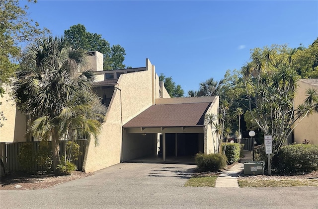 204 Tomoka Trl Unit 204, Longwood, FL 32779 - exterior space featuring driveway, stucco siding, and fence