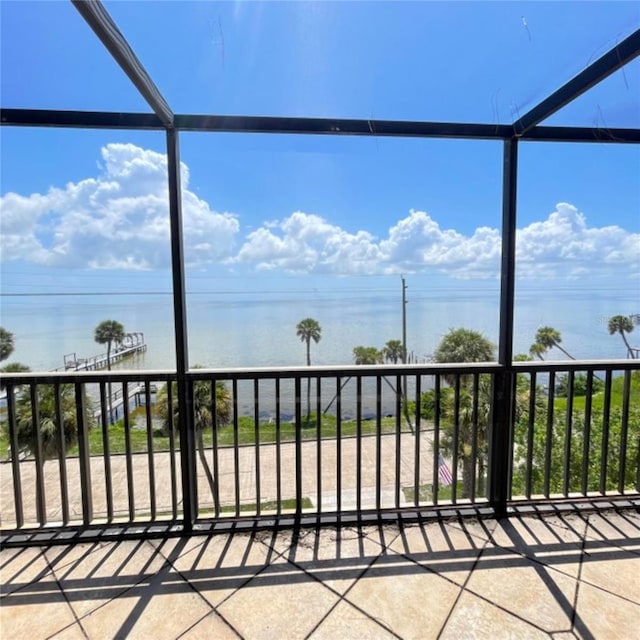 exterior space featuring a balcony and a water view