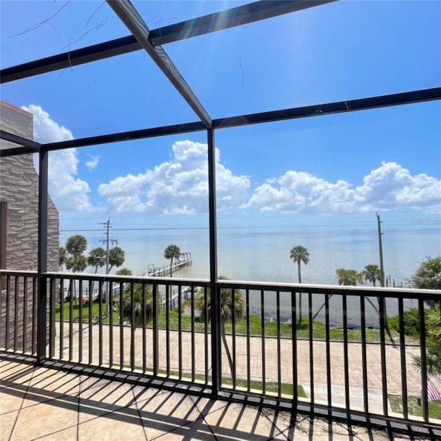 exterior space featuring a lanai, a balcony, and a water view