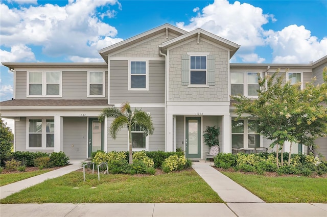 11038 Leafshore Loop, Orlando, FL 32829 - townhome / multi-family property featuring a front yard