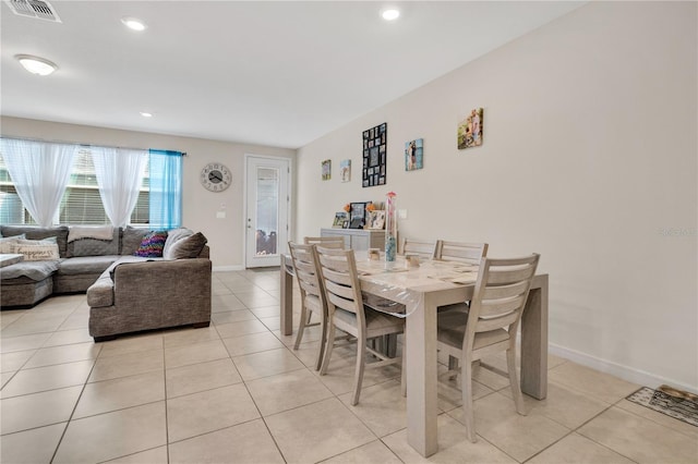 11038 Leafshore Loop, Orlando, FL 32829 - dining area with light tile patterned floors and recessed lighting