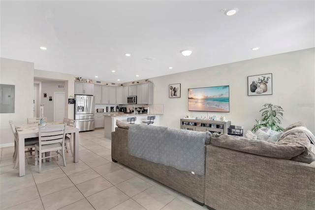 11038 Leafshore Loop, Orlando, FL 32829 - living area with light tile patterned floors, electric panel, and recessed lighting