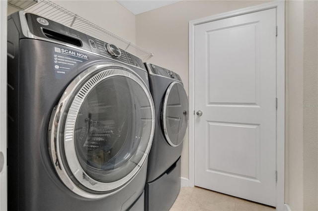 11038 Leafshore Loop, Orlando, FL 32829 - washroom featuring washer and dryer and light tile patterned flooring