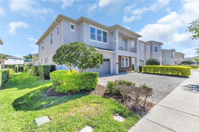 501 Burma St, Kissimmee, FL 34747 - view of front of property with a front yard, decorative driveway, a residential view, and stucco siding