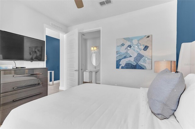 501 Burma St, Kissimmee, FL 34747 - tiled bedroom featuring visible vents, a ceiling fan, and ensuite bathroom