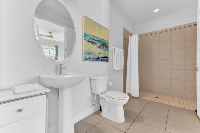 501 Burma St, Kissimmee, FL 34747 - bathroom with recessed lighting, a tile shower, ceiling fan, tile patterned floors, and toilet
