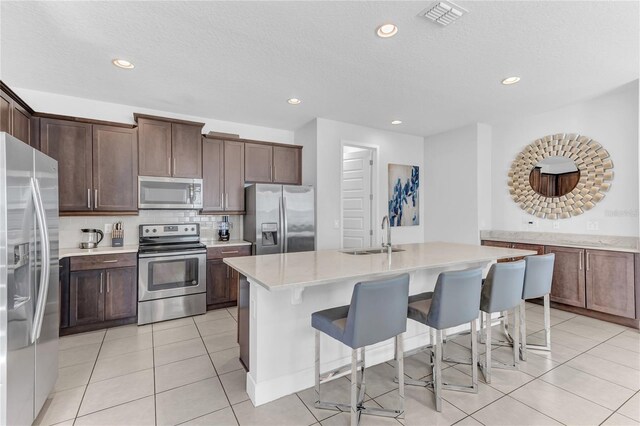 501 Burma St, Kissimmee, FL 34747 - kitchen featuring visible vents, a sink, tasteful backsplash, appliances with stainless steel finishes, and light countertops
