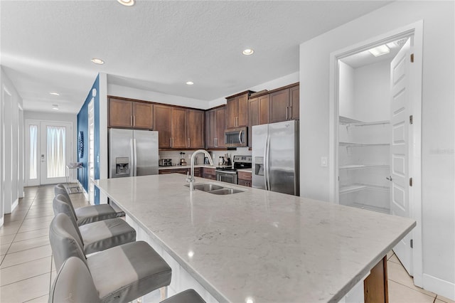 501 Burma St, Kissimmee, FL 34747 - kitchen with a large island, appliances with stainless steel finishes, light stone countertops, and a sink