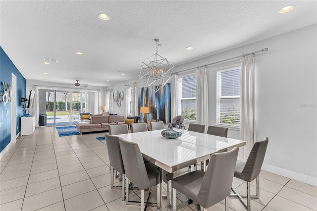 501 Burma St, Kissimmee, FL 34747 - dining area featuring baseboards, ceiling fan with notable chandelier, recessed lighting, light tile patterned flooring, and a textured ceiling
