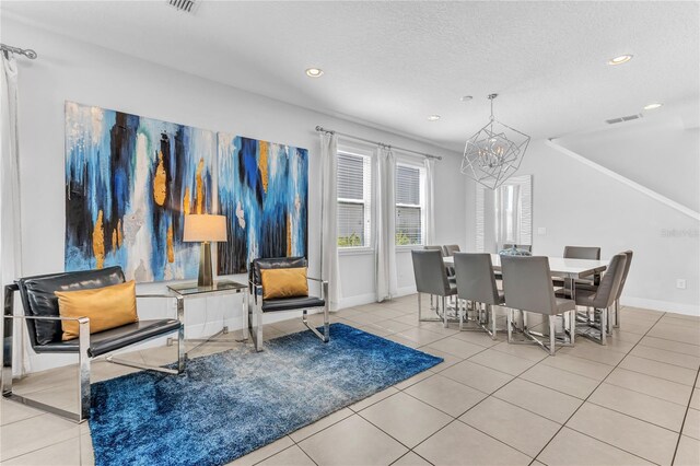 501 Burma St, Kissimmee, FL 34747 - tiled dining room with baseboards, visible vents, recessed lighting, a textured ceiling, and a notable chandelier