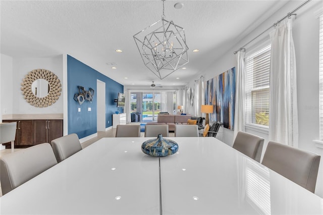 501 Burma St, Kissimmee, FL 34747 - dining area with baseboards, recessed lighting, a textured ceiling, and an inviting chandelier