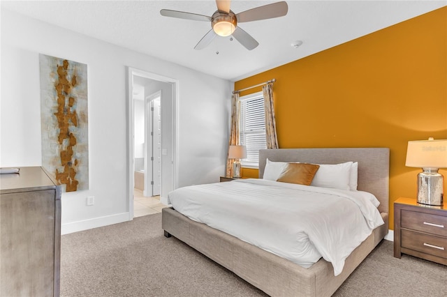501 Burma St, Kissimmee, FL 34747 - bedroom featuring ceiling fan, light colored carpet, baseboards, and connected bathroom