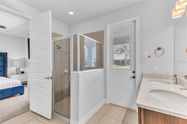 501 Burma St, Kissimmee, FL 34747 - bathroom featuring tile patterned floors, a stall shower, ensuite bathroom, and a sink