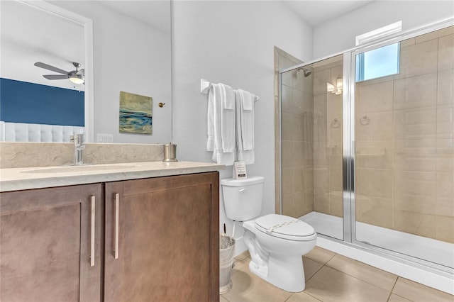 501 Burma St, Kissimmee, FL 34747 - bathroom with tile patterned floors, a stall shower, toilet, and a ceiling fan