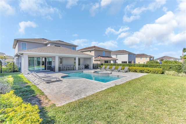 501 Burma St, Kissimmee, FL 34747 - view of swimming pool with a patio, a pool with connected hot tub, a yard, and fence