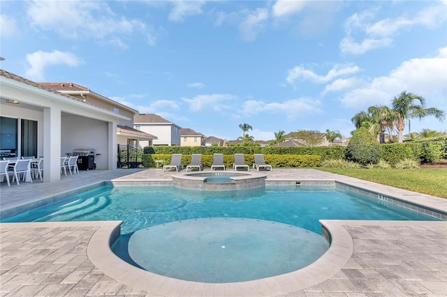 501 Burma St, Kissimmee, FL 34747 - view of swimming pool featuring area for grilling, a pool with connected hot tub, and a patio