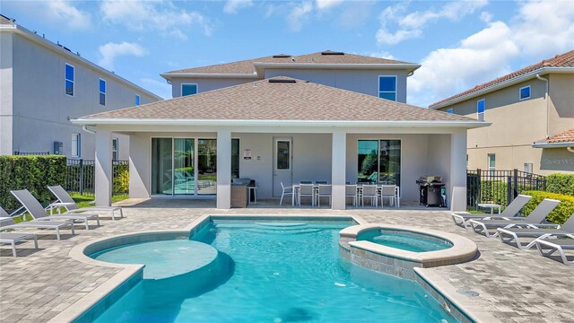 501 Burma St, Kissimmee, FL 34747 - view of pool featuring a patio area, a grill, a pool with connected hot tub, and fence