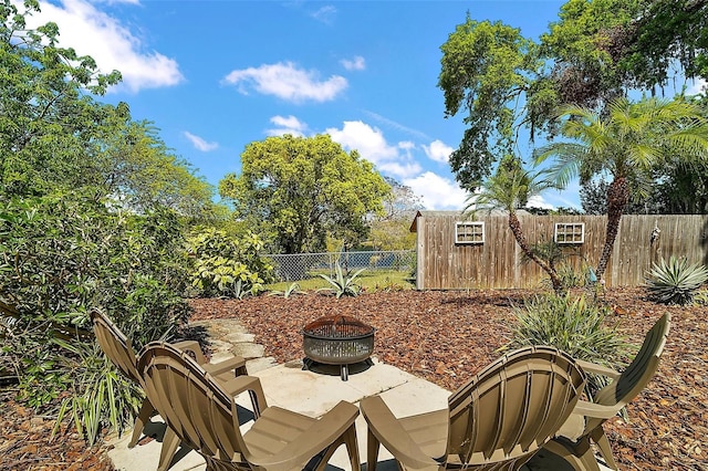view of patio / terrace featuring a fenced backyard and an outdoor fire pit