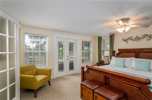 bedroom with access to outside, french doors, light colored carpet, and a textured ceiling
