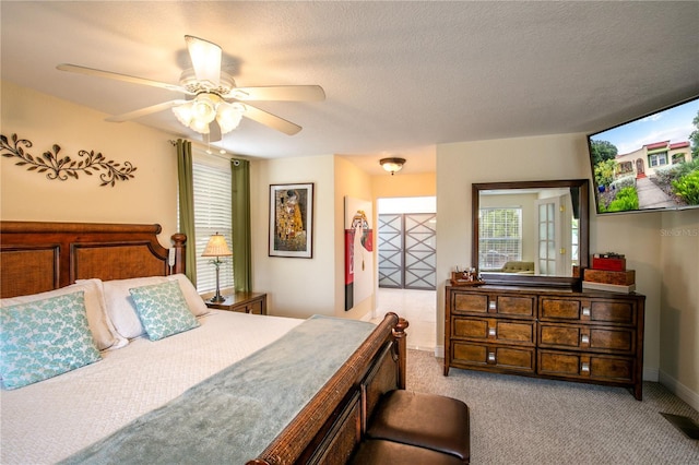 bedroom featuring baseboards, carpet, ceiling fan, and a textured ceiling