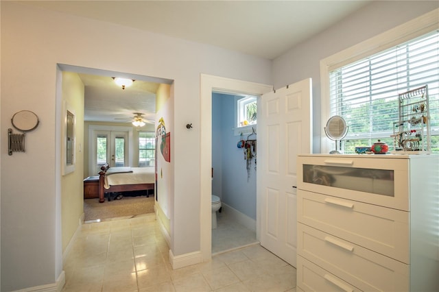hall with light tile patterned floors and baseboards