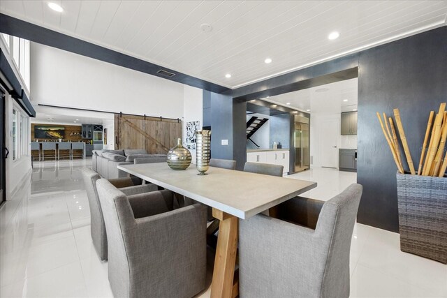 7841 Georgeann St, Winter Park, FL 32792 - dining space with a barn door, light tile patterned floors, recessed lighting, and wood ceiling