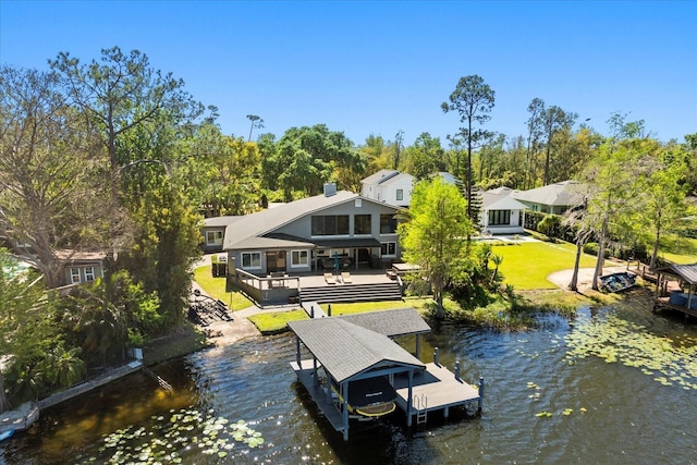 7841 Georgeann St, Winter Park, FL 32792 - dock featuring a yard, a deck with water view, view of scattered trees, and boat lift