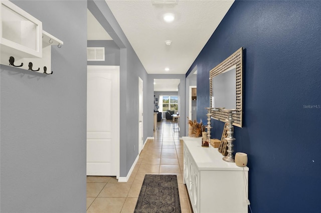 11207 Amber Ridge Dr, Zellwood, FL 32798 - corridor featuring baseboards, visible vents, and light tile patterned floors