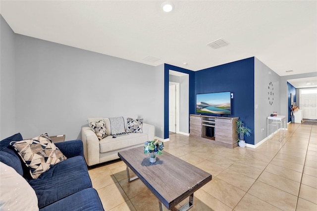 11207 Amber Ridge Dr, Zellwood, FL 32798 - living room with baseboards, visible vents, and light tile patterned floors