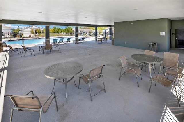 11207 Amber Ridge Dr, Zellwood, FL 32798 - view of patio with a community pool, fence, and radiator heating unit