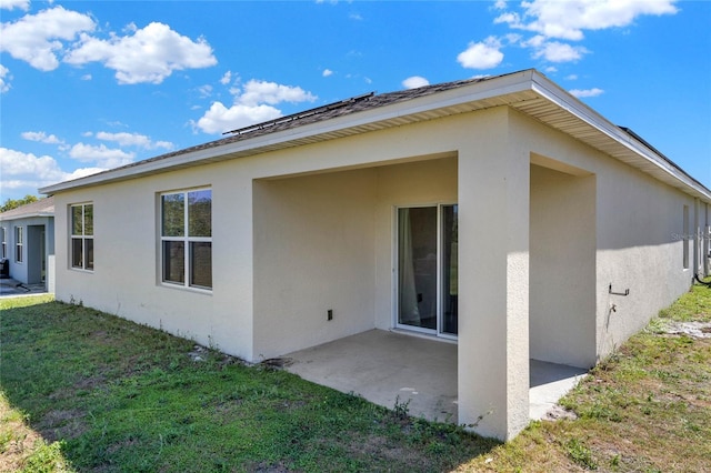 11207 Amber Ridge Dr, Zellwood, FL 32798 - rear view of house with stucco siding, a yard, and a patio area
