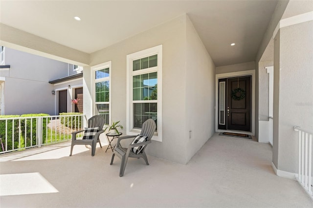 entrance to property featuring stucco siding