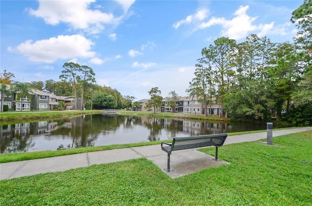 surrounding community with a lawn, a water view, and a residential view