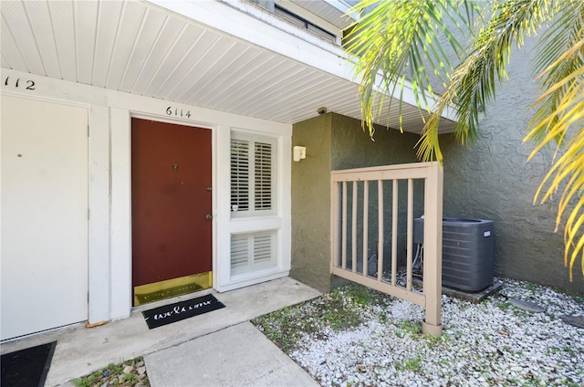 6114 Peregrine Ave Unit D03, Orlando, FL 32819 - view of exterior entry with stucco siding and central AC unit
