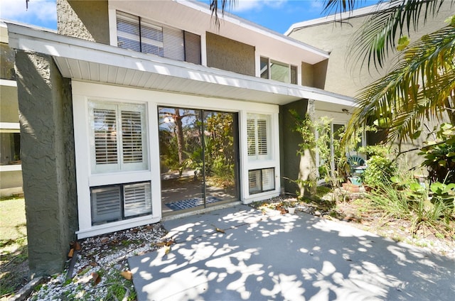 6114 Peregrine Ave Unit D03, Orlando, FL 32819 - property entrance with stucco siding and a patio