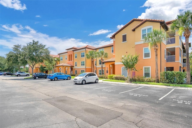 5471 Vineland Rd Unit 7108, Orlando, FL 32811 - uncovered parking lot with a residential view