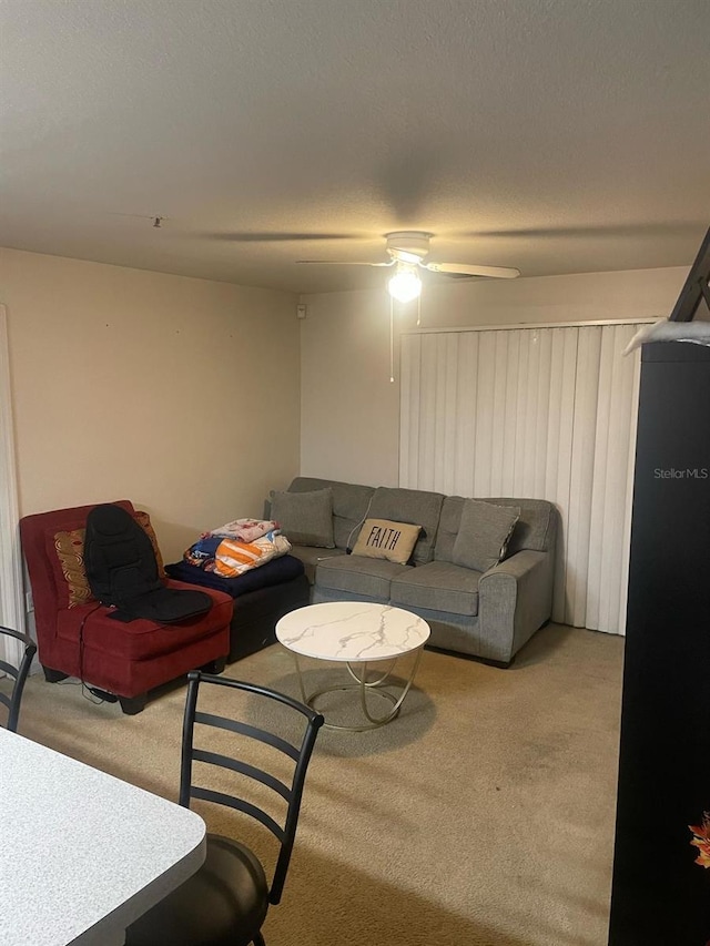5471 Vineland Rd Unit 7108, Orlando, FL 32811 - living room with a ceiling fan, carpet floors, and a textured ceiling