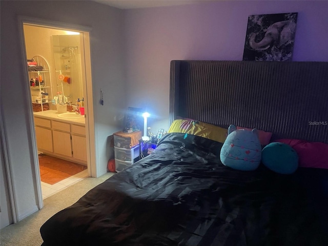 5471 Vineland Rd Unit 7108, Orlando, FL 32811 - bedroom featuring connected bathroom, a sink, and light colored carpet
