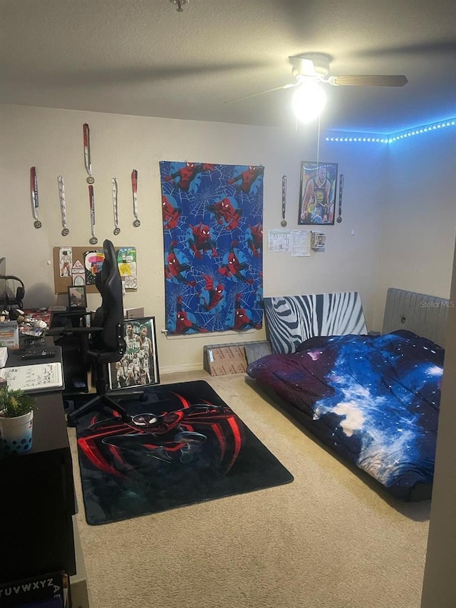 5471 Vineland Rd Unit 7108, Orlando, FL 32811 - bedroom featuring a textured ceiling, carpet floors, and a ceiling fan