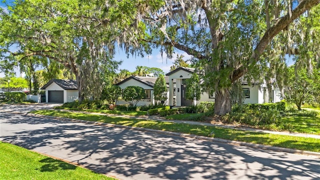 1701 Palmer Ave, Winter Park, FL 32789 - view of front of property with stucco siding, an attached garage, and concrete driveway