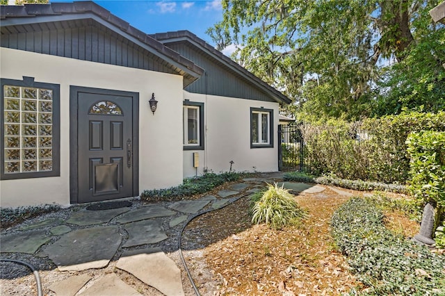 1701 Palmer Ave, Winter Park, FL 32789 - view of exterior entry with stucco siding and fence