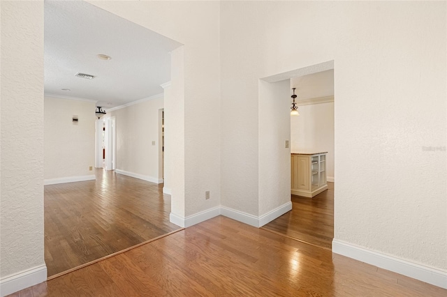 1701 Palmer Ave, Winter Park, FL 32789 - empty room featuring crown molding, wood finished floors, visible vents, and baseboards