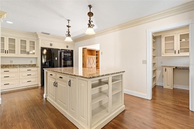1701 Palmer Ave, Winter Park, FL 32789 - kitchen featuring dark wood-style floors, a kitchen island, black appliances, and light stone countertops