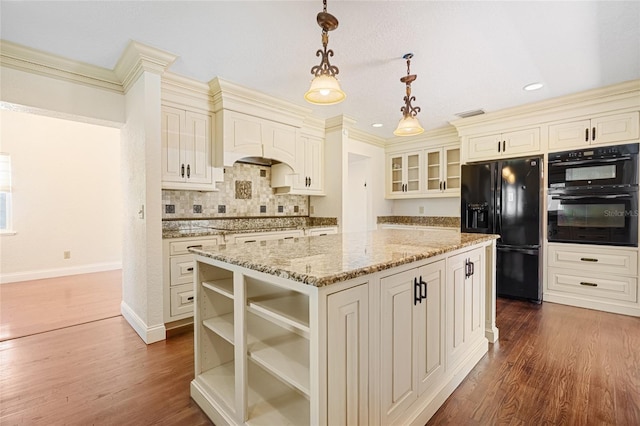 1701 Palmer Ave, Winter Park, FL 32789 - kitchen featuring light stone counters, dark wood-style floors, a kitchen island, black appliances, and cream cabinets