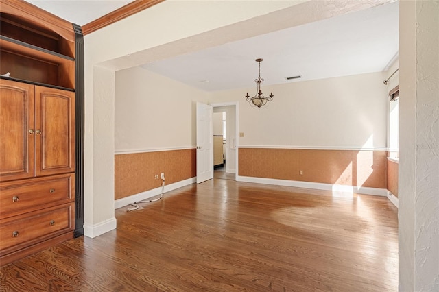 1701 Palmer Ave, Winter Park, FL 32789 - unfurnished room with baseboards, visible vents, an inviting chandelier, dark wood-style flooring, and wainscoting