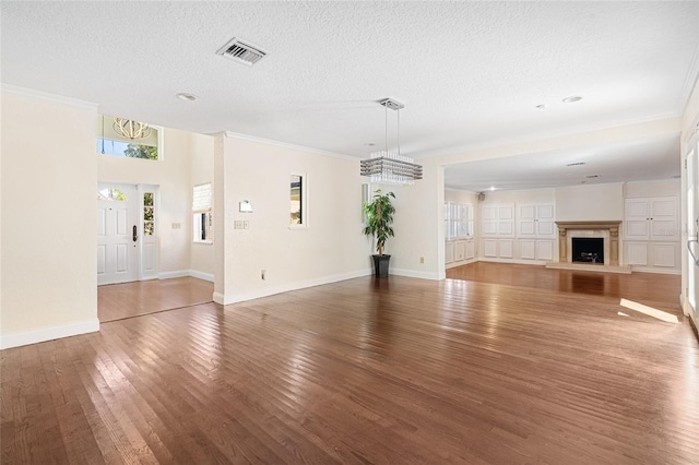 1701 Palmer Ave, Winter Park, FL 32789 - unfurnished living room with visible vents, a textured ceiling, wood-type flooring, an inviting chandelier, and baseboards
