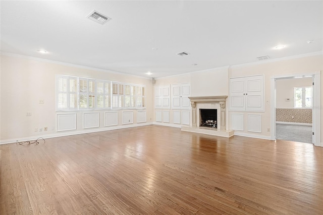 1701 Palmer Ave, Winter Park, FL 32789 - unfurnished living room featuring crown molding, light wood-style flooring, and visible vents