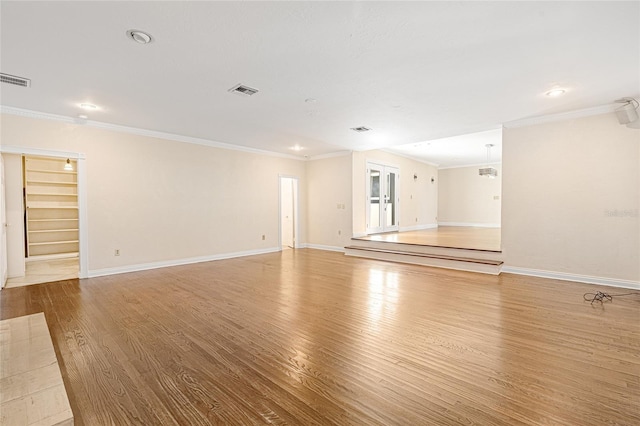 1701 Palmer Ave, Winter Park, FL 32789 - unfurnished living room with visible vents, baseboards, light wood-style flooring, and crown molding